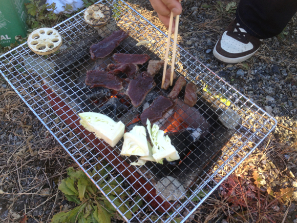 宮崎高原町の牧浩之さんが今日の七輪会のために、猟したキュウシュウシカを送ってくれた。罠にかかったバンビを牧さんが止め刺し（とどめを刺すこと）している携帯写真をみんなに提示する。その上で9歳児に「このシカはだな、牧さんが獲って自分の手で殺して血を抜いて皮をはいで肉をそいで...」と、いま七輪の上で焼かれているまでの過程をことこまかに説明した。「わかったか。わかったなら食べなさい」。超うまい。牧さんがていねいにこしらえているのが伝わってくるおいしさ。お肉は人柄だ。